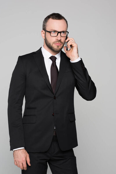 concerned young businessman talking on phone 