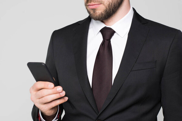 businessman looking at smartphone