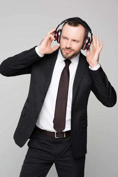 young businessman listening to music 