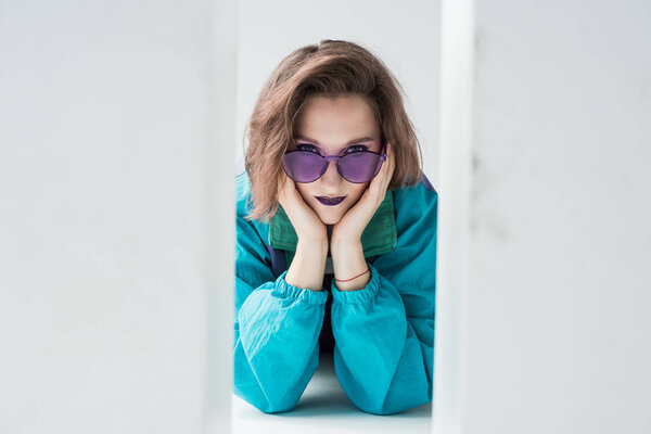 girl in windcheater jacket and purple sunglasses