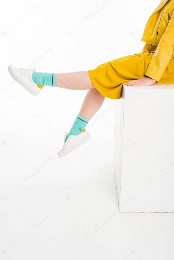 girl dressed in yellow with turqouise socks