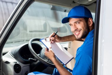 delivery man filling in documents