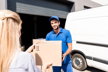 courier giving package to woman clipart