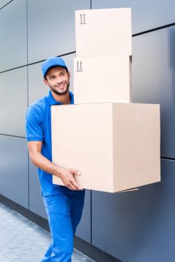 delivery man with stack of boxes clipart
