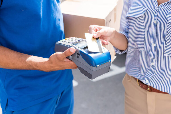 woman paying for delivery with card