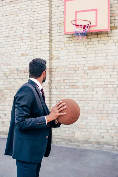 Businessman with basketball ball — Stock Photo, Image
