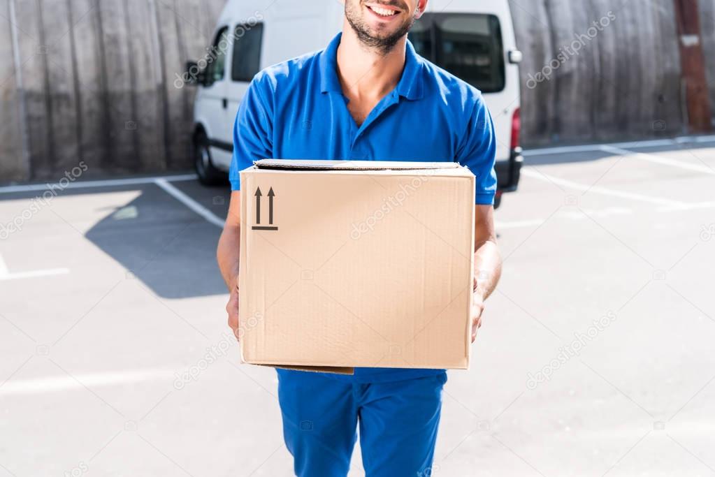 delivery man with cardboard box