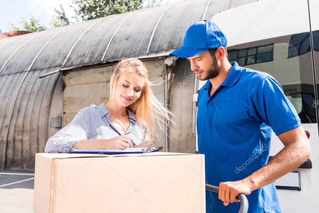 woman signing delivery document