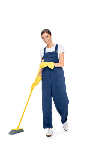 smiling cleaner in uniform with broom