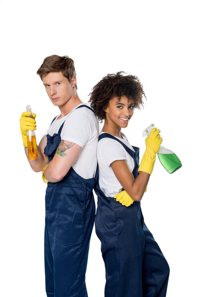 multiethnic cleaners with cleaning supplies