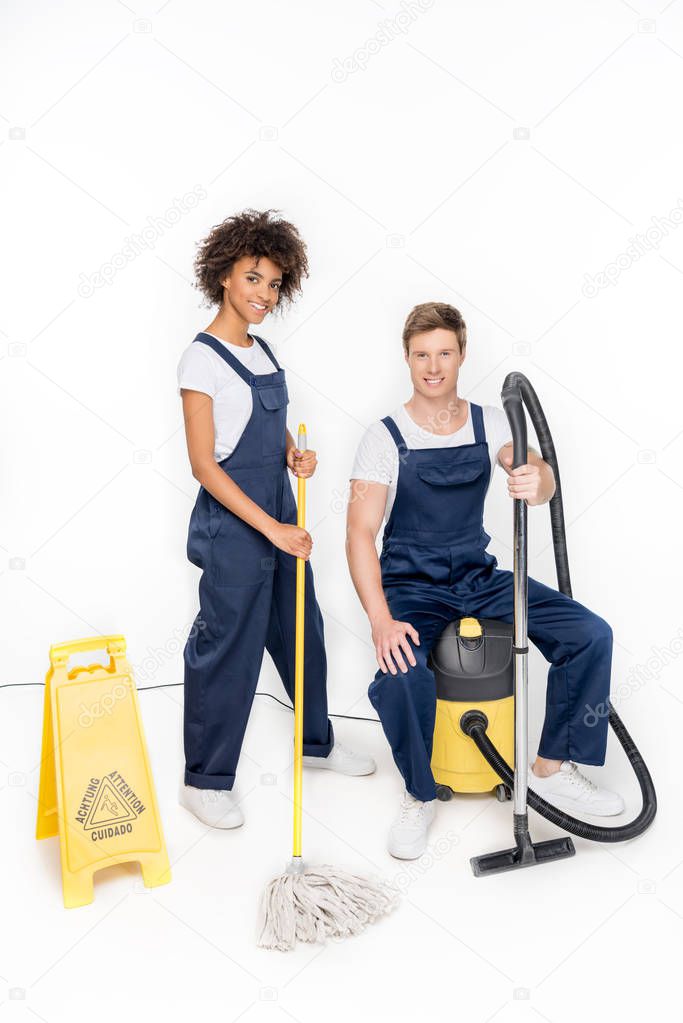 multiethnic cleaners with cleaning supplies