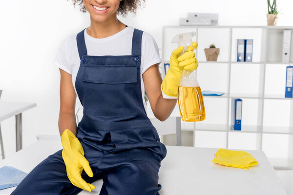 african american cleaner with spray bottle 