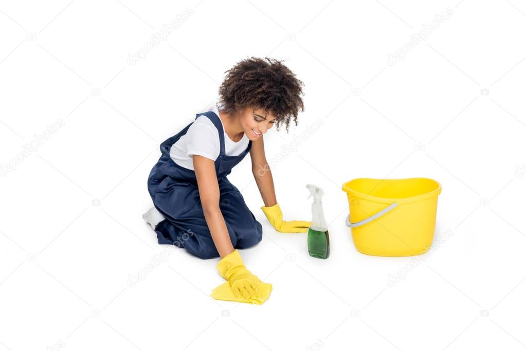 african american cleaner tidying floor