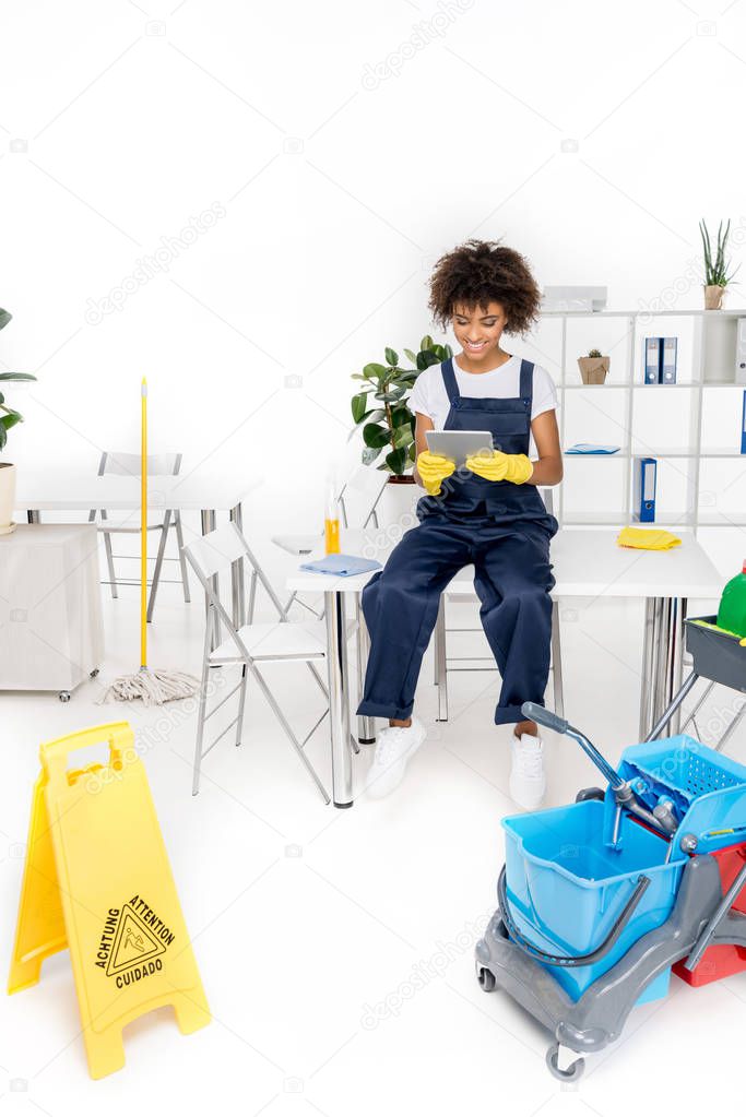 african american cleaner with digital tablet