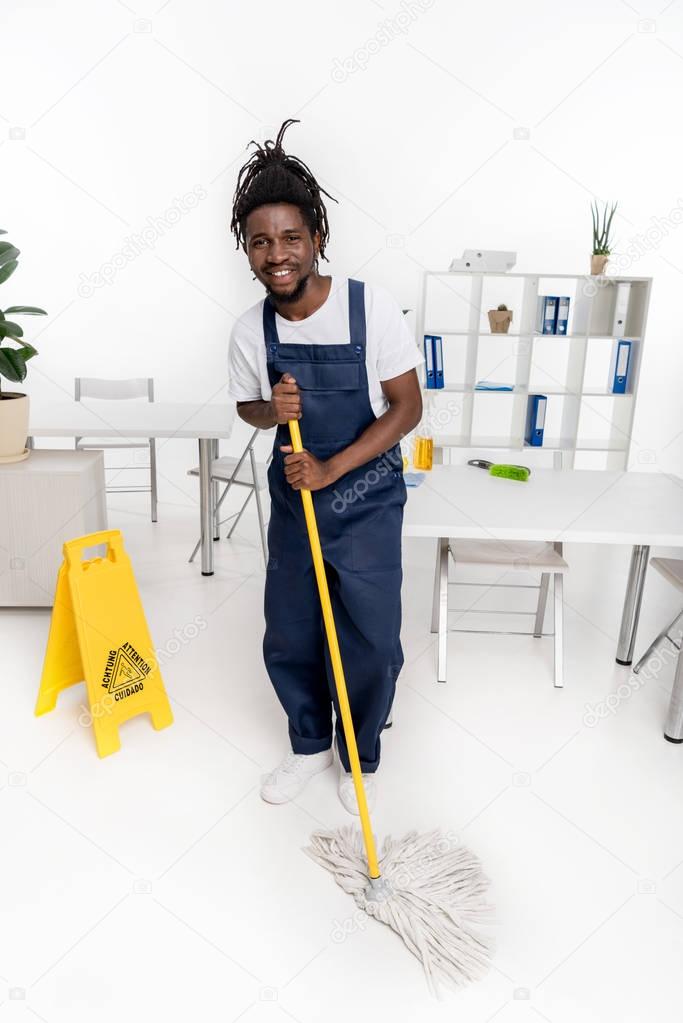 african american cleaner with mop