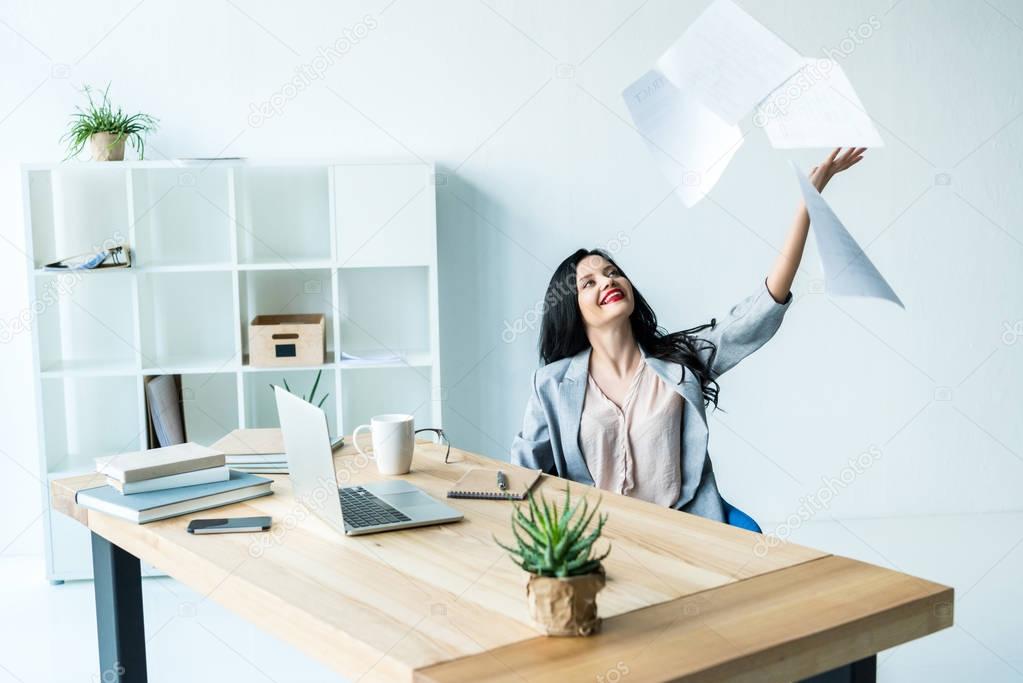 businesswoman throwing documents away