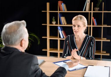 woman asking businessman for advice clipart