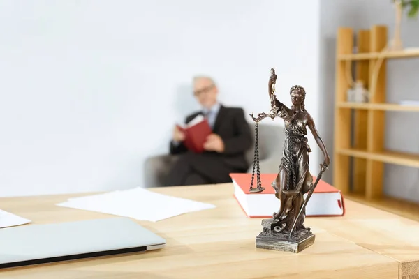 Lawyer workplace with themis statue — Stock Photo, Image