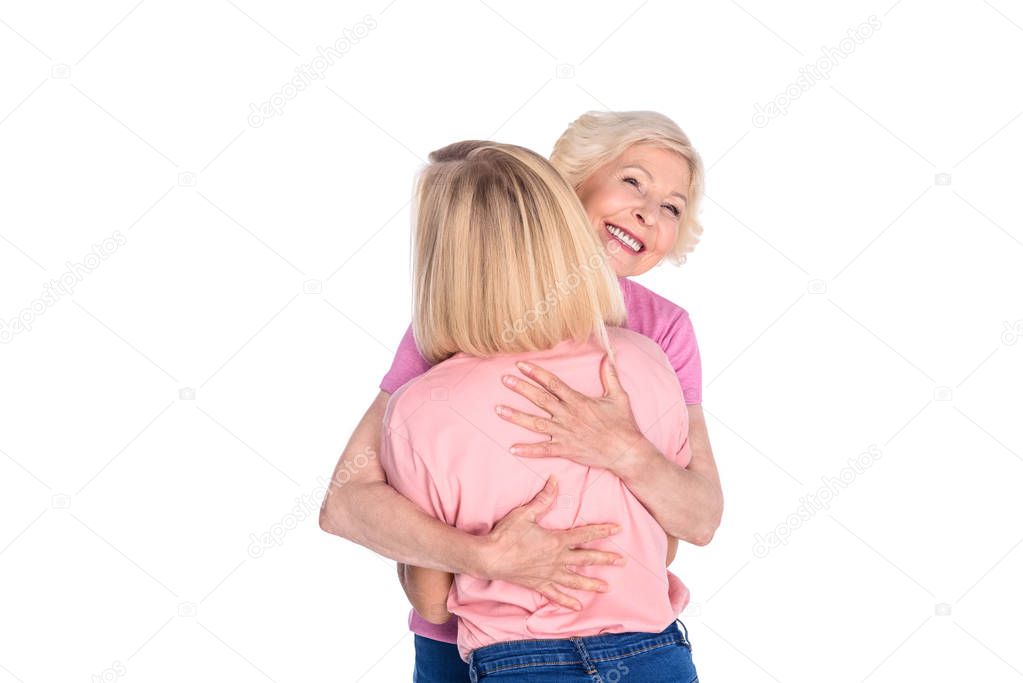 women in pink t-shirts hugging