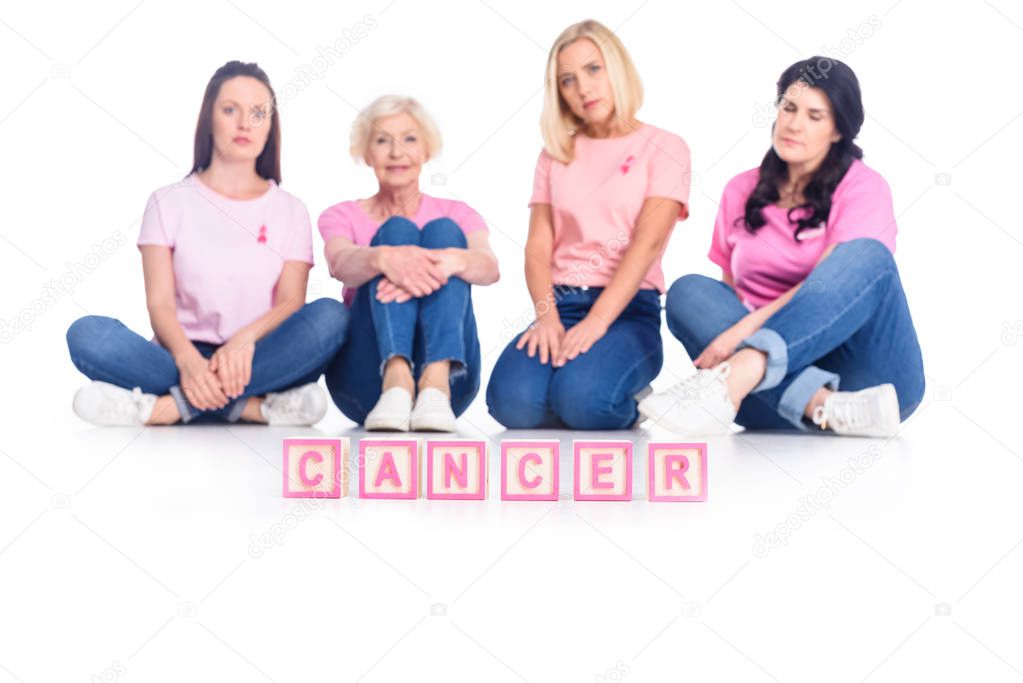 women in pink t-shirts with cancer inscription
