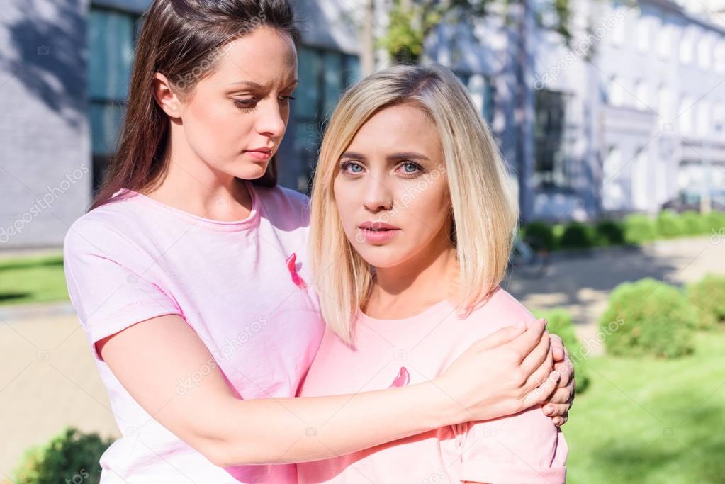 women in pink t-shirts embracing