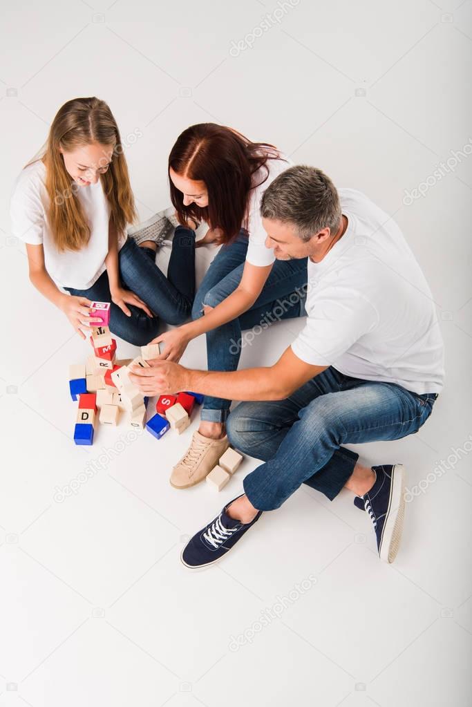 family playing with alphabet blocks