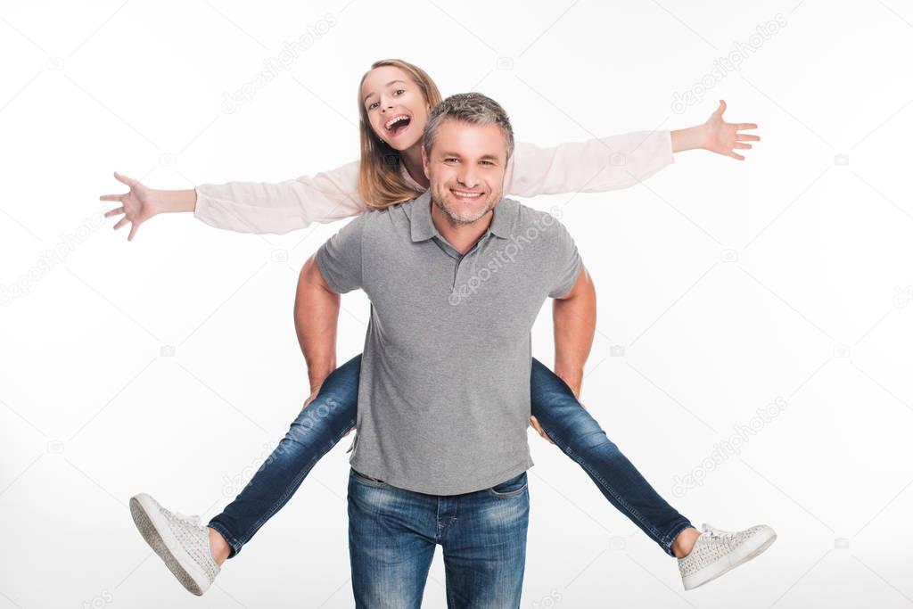 father piggybacking his daughter