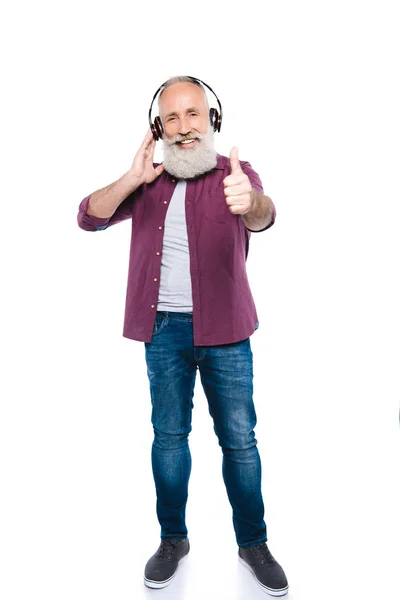 Hombre mayor escuchando música con auriculares —  Fotos de Stock