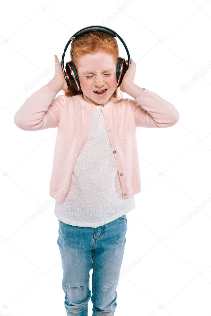 child listening music with headphones