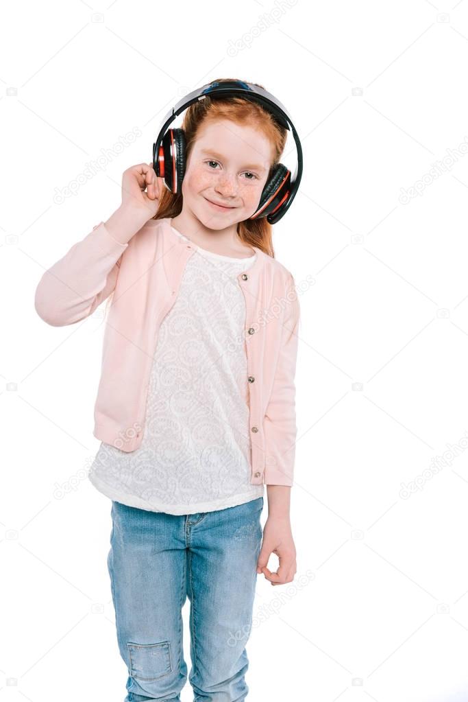 child listening music with headphones