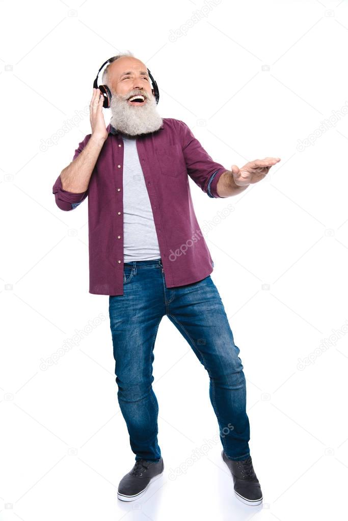 senior man dancing and listening music  