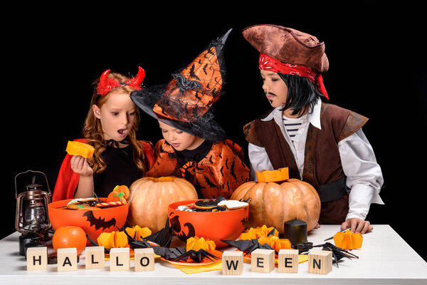 kids making halloween jack o lanterns