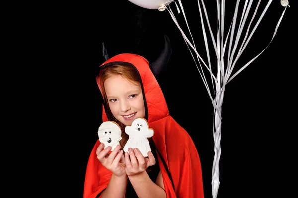 Child in costume of devil with cookies — Stock Photo, Image