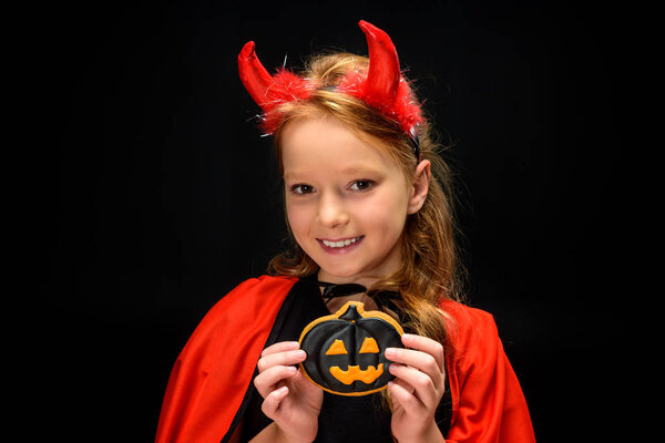 little devil with halloween pumpkin cookie