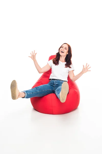 Excited woman on bean bag chair — Stock Photo, Image