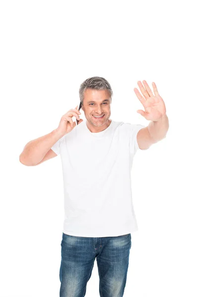 Homem acenando e usando smartphone — Fotografia de Stock