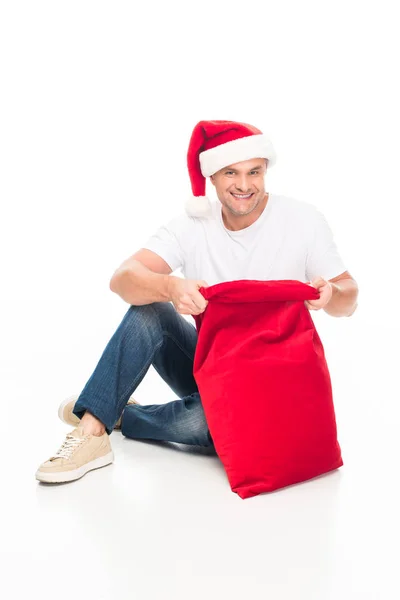 Homme en chapeau de Père Noël avec sac — Photo