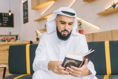 muslim man reading quran clipart