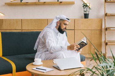 muslim man reading quran clipart