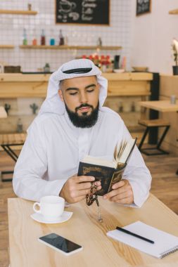 muslim man reading quran clipart