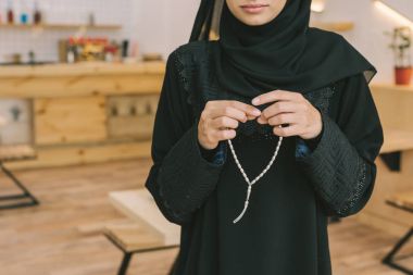 muslim woman with prayer beads clipart