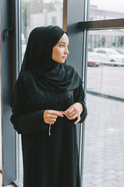 muslim woman looking at window clipart