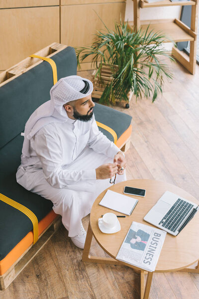 muslim businessman sitting on sofa