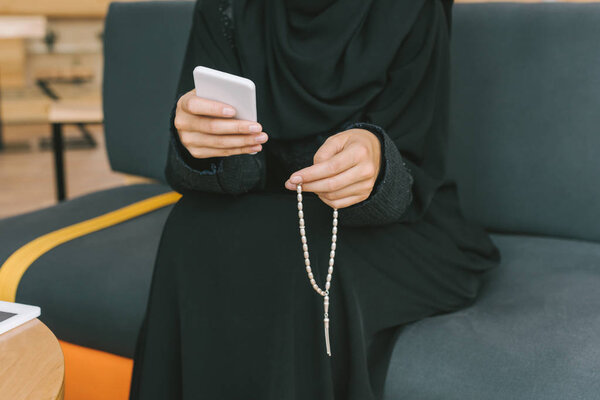 muslim woman with smartphone