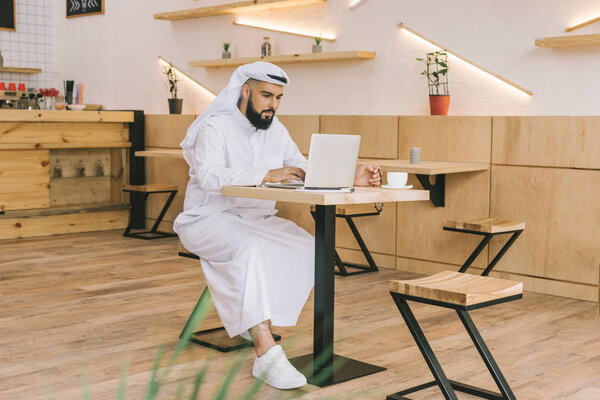 muslim man using laptop