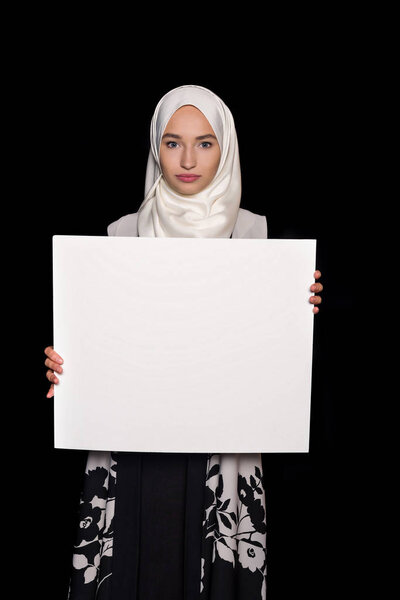 muslim woman holding blank board