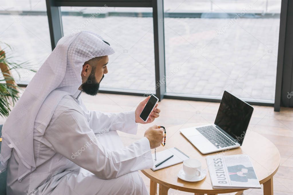 muslim businessman using smartphone