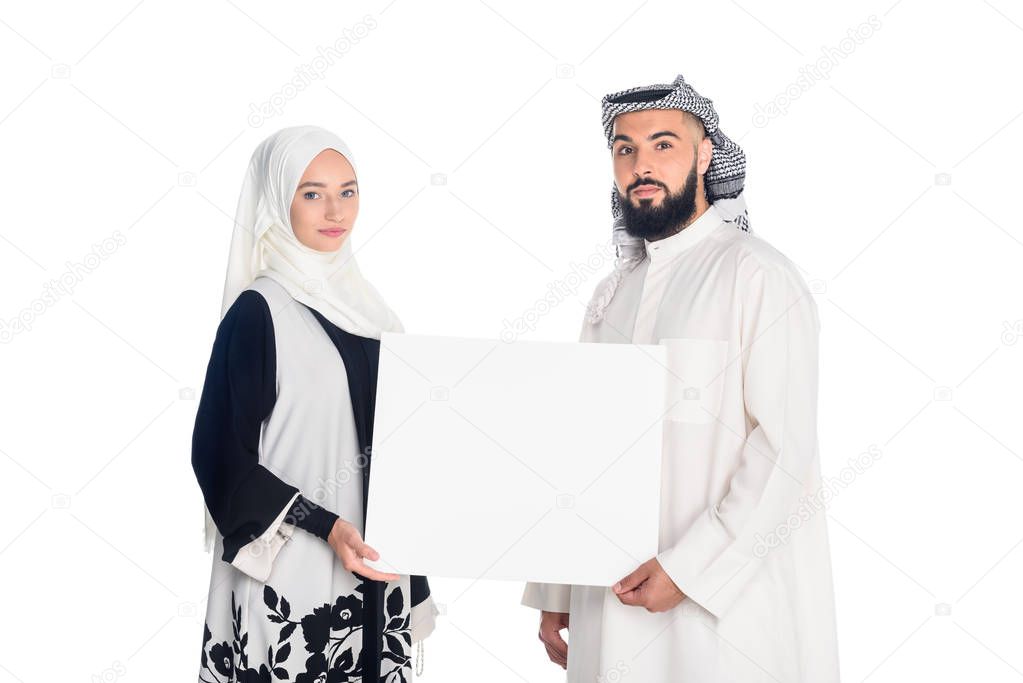 muslim couple holding blank board