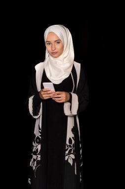muslim woman using smartphone clipart