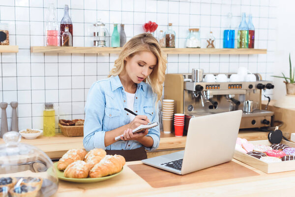 cafe owner taking notes